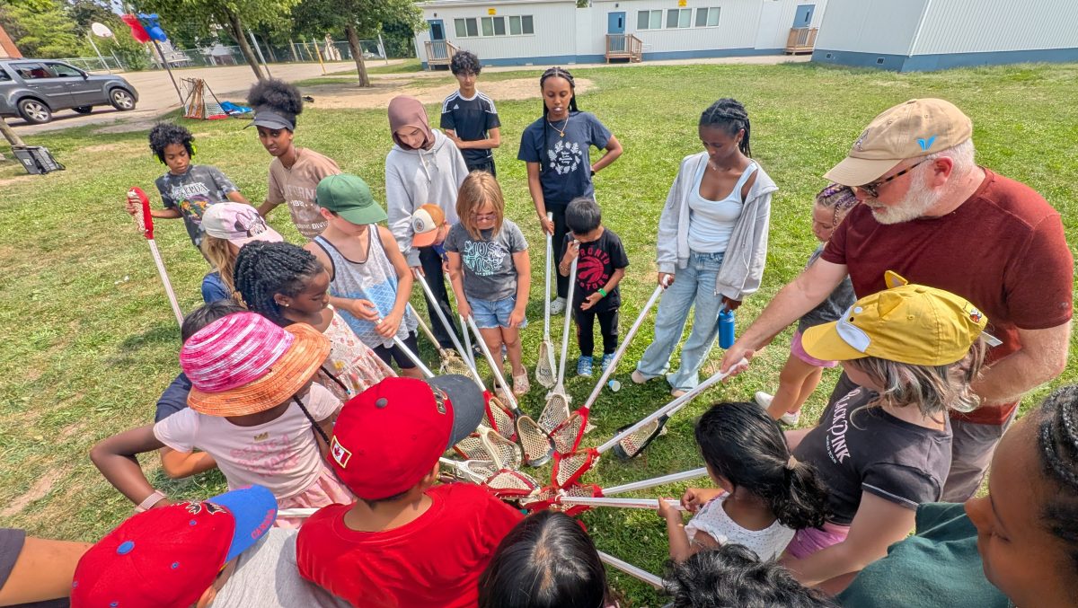 Day Camp campers learning to play lacrosse